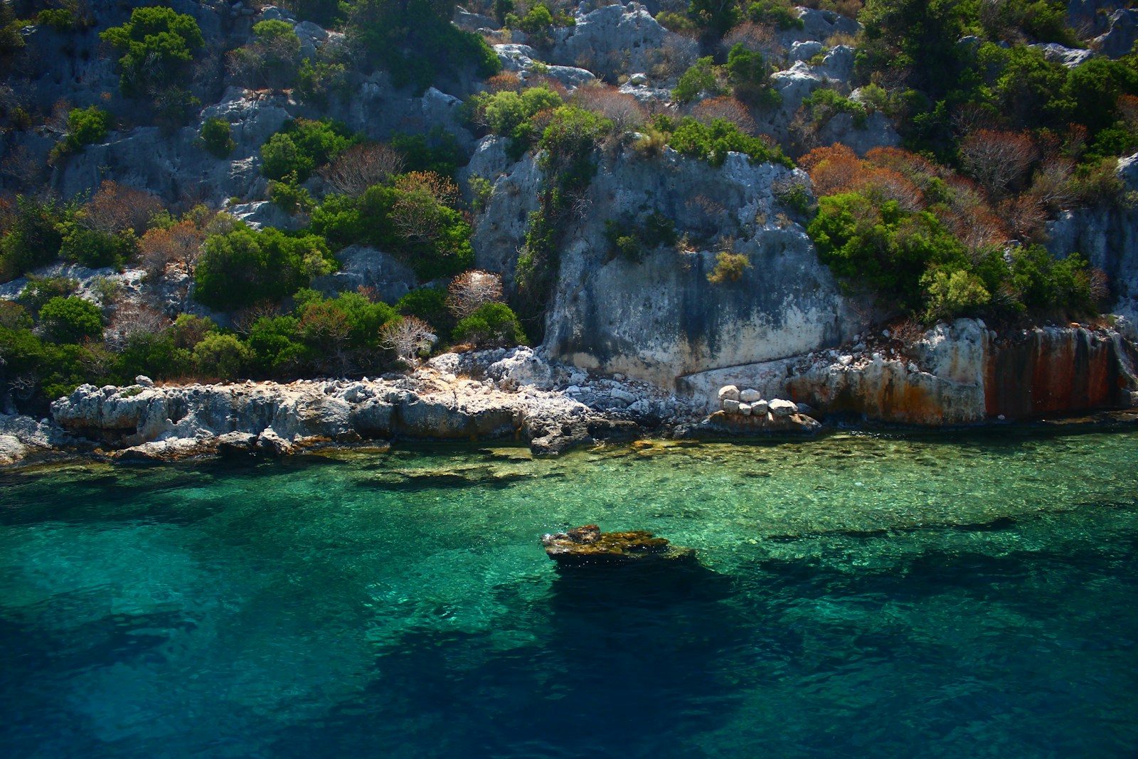 Clear turquoise Mediterranean water along a rocky island coastline in the Balearic Islands