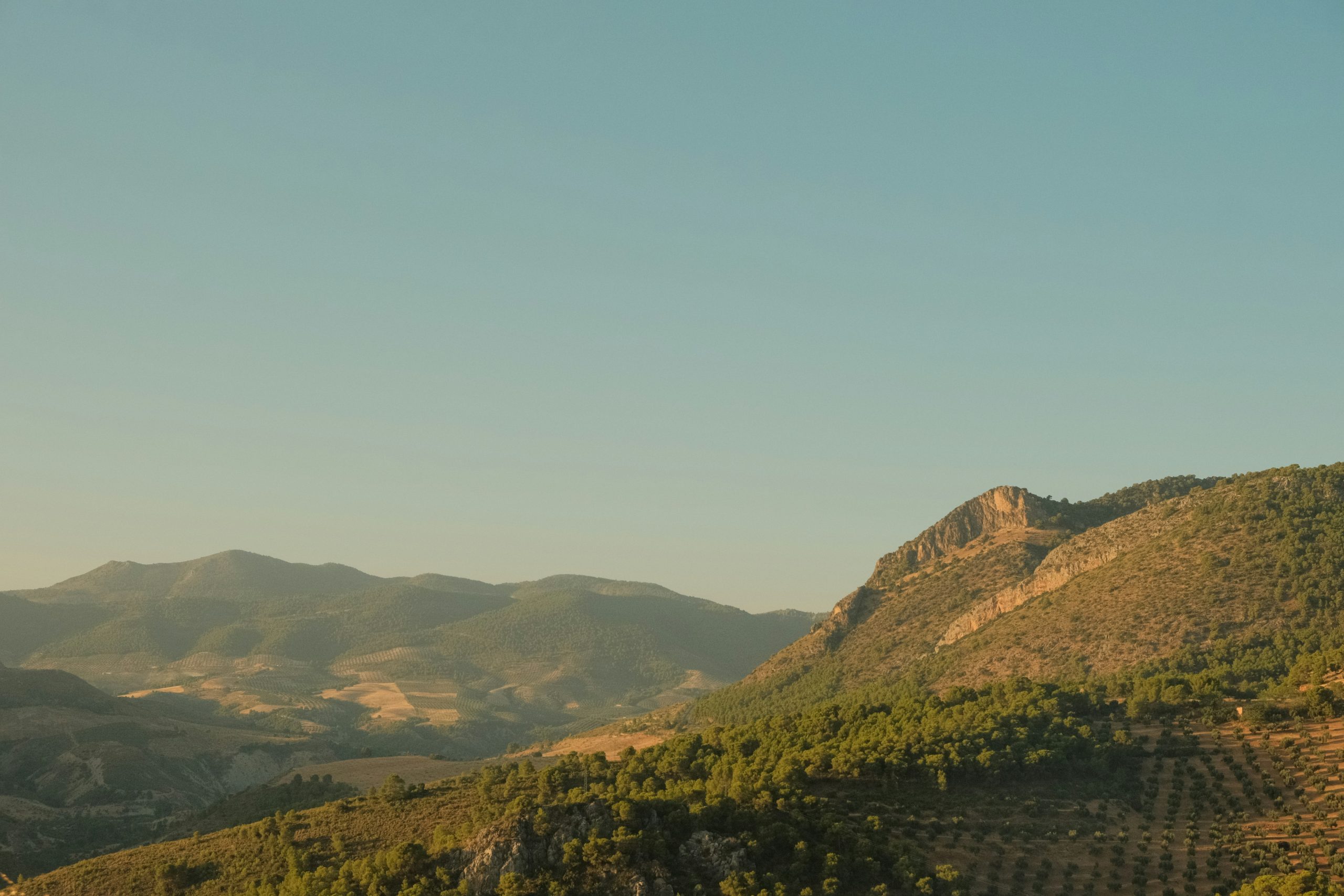 Rolling Spanish hills and distant mountains in sunshine