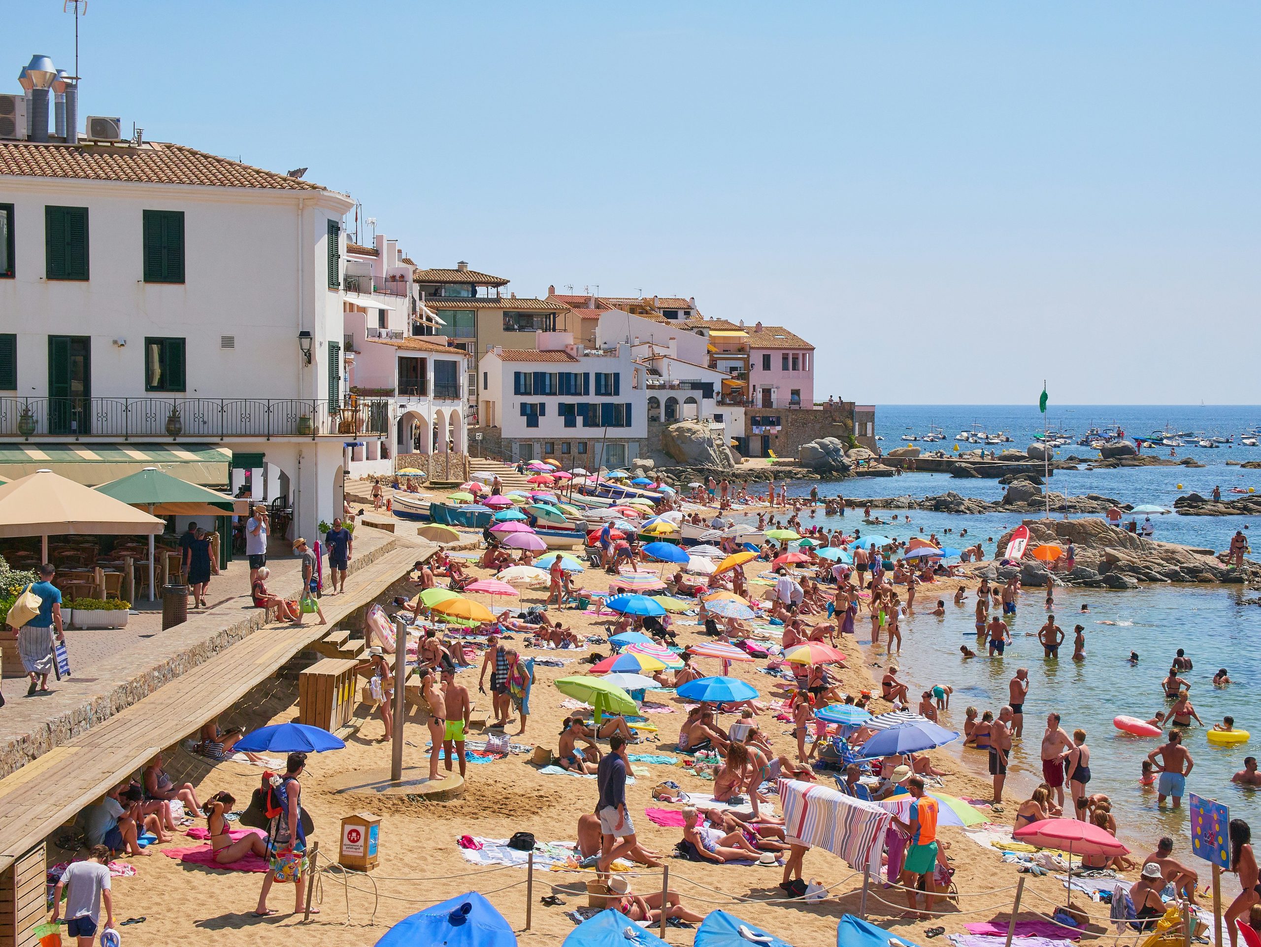 Sunny Mediterranean beach with colourful umbrellas near Calella