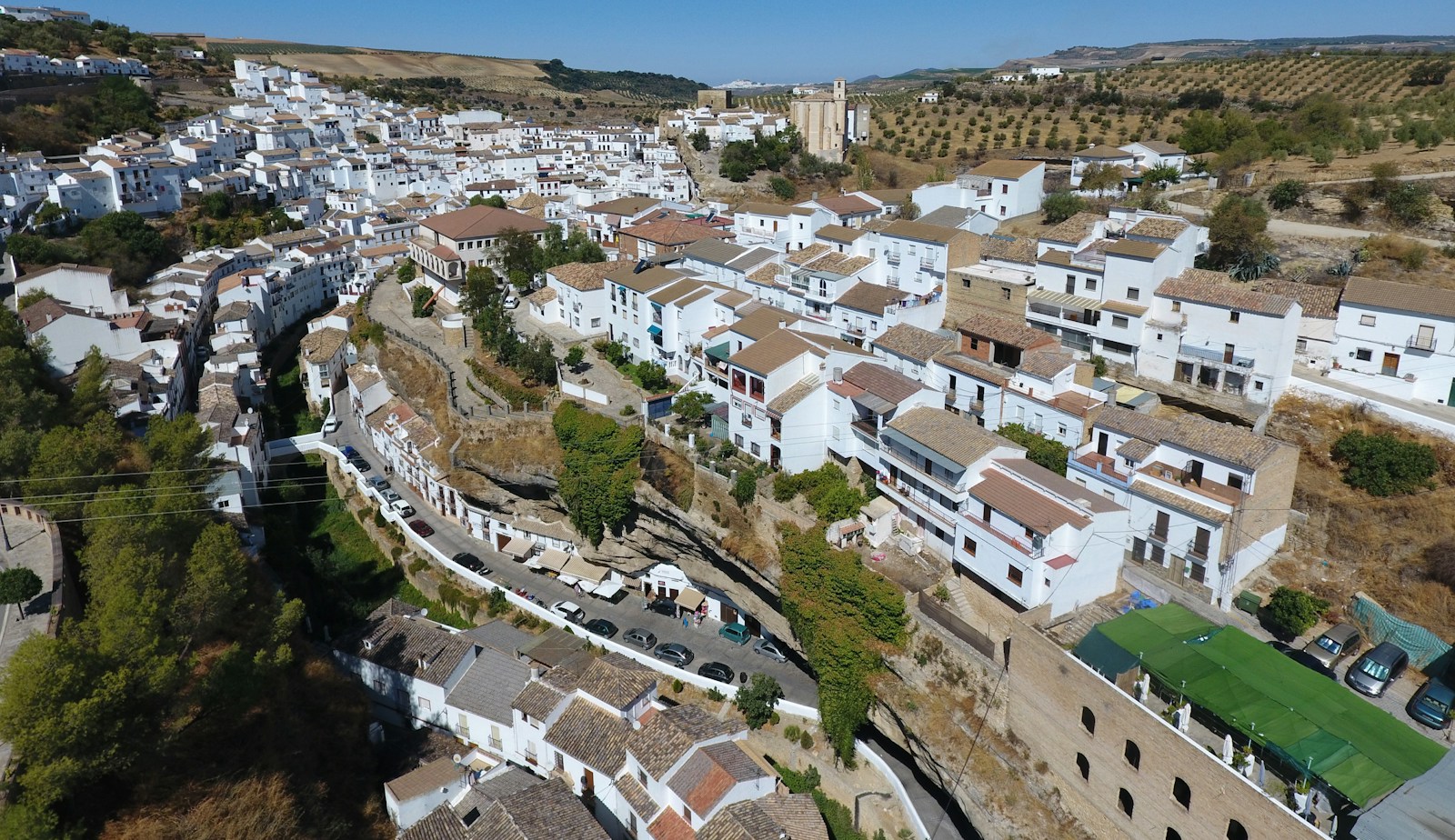 White buildings in an Andalusian town surrounded by landscape