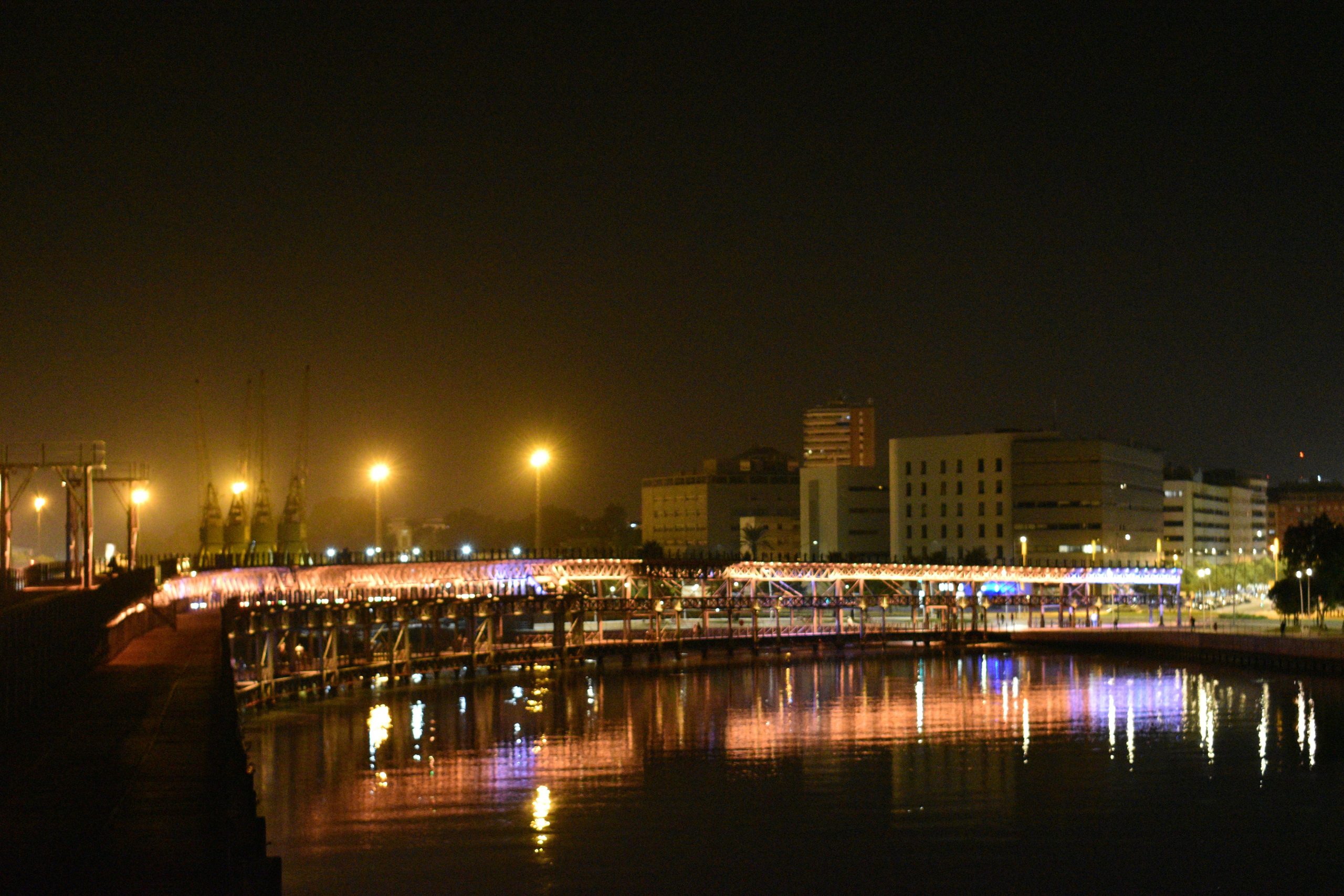 Evening view of a Spanish city waterfront and bridge representing Huelva web design services