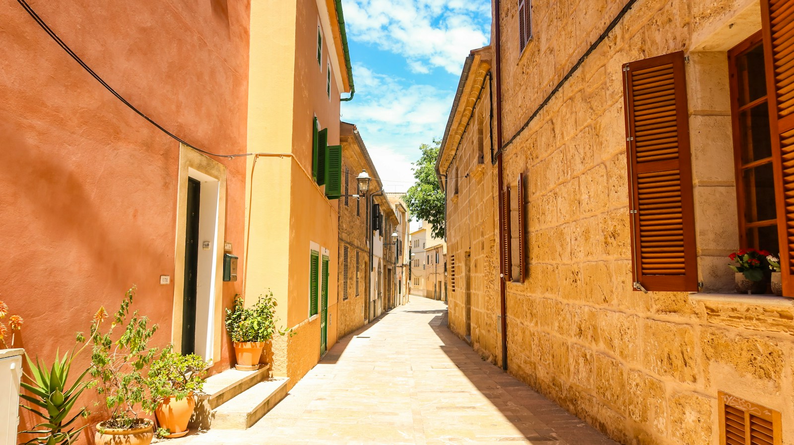 Narrow traditional stone village street with Mediterranean architecture in Mallorca